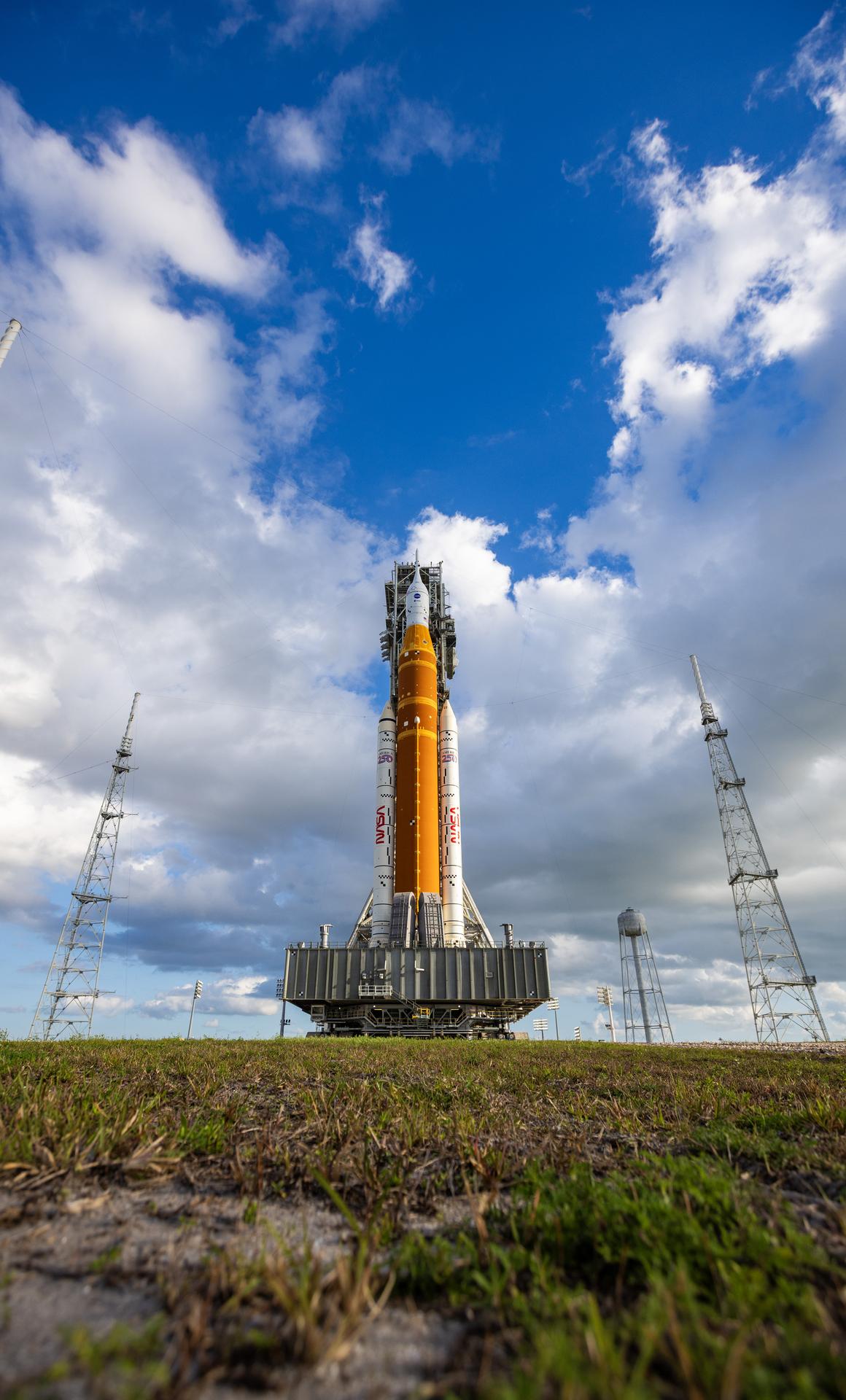 This image shows NASA’s SLS (Space Launch System) and Orion spacecraft rolling out of the Vehicle Assembly Building at NASA’s Kennedy Space Center. NASA's massive Crawler-Transporter, upgraded for the Artemis program, carries the powerful SLS rocket and Orion spacecraft on the Mobile Launcher from the Vehicle Assembly Building to Launch Pad 39B at Kennedy Space Center in preparation for the Artemis II mission.